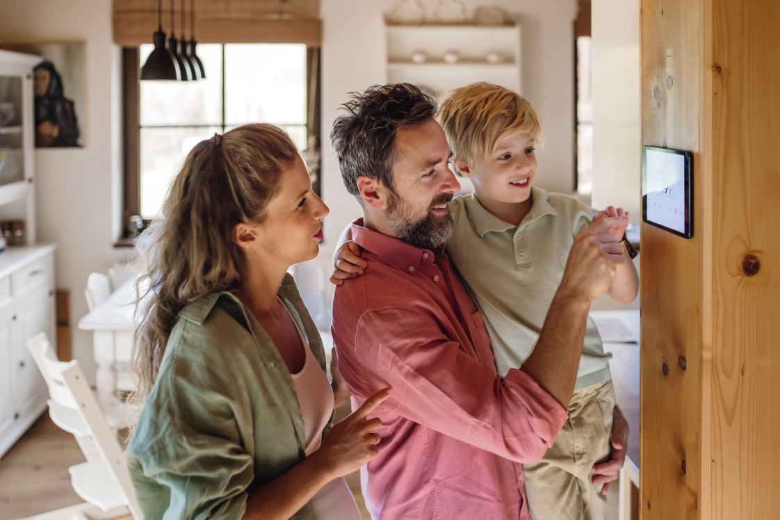 Family Adjusting Thermostat